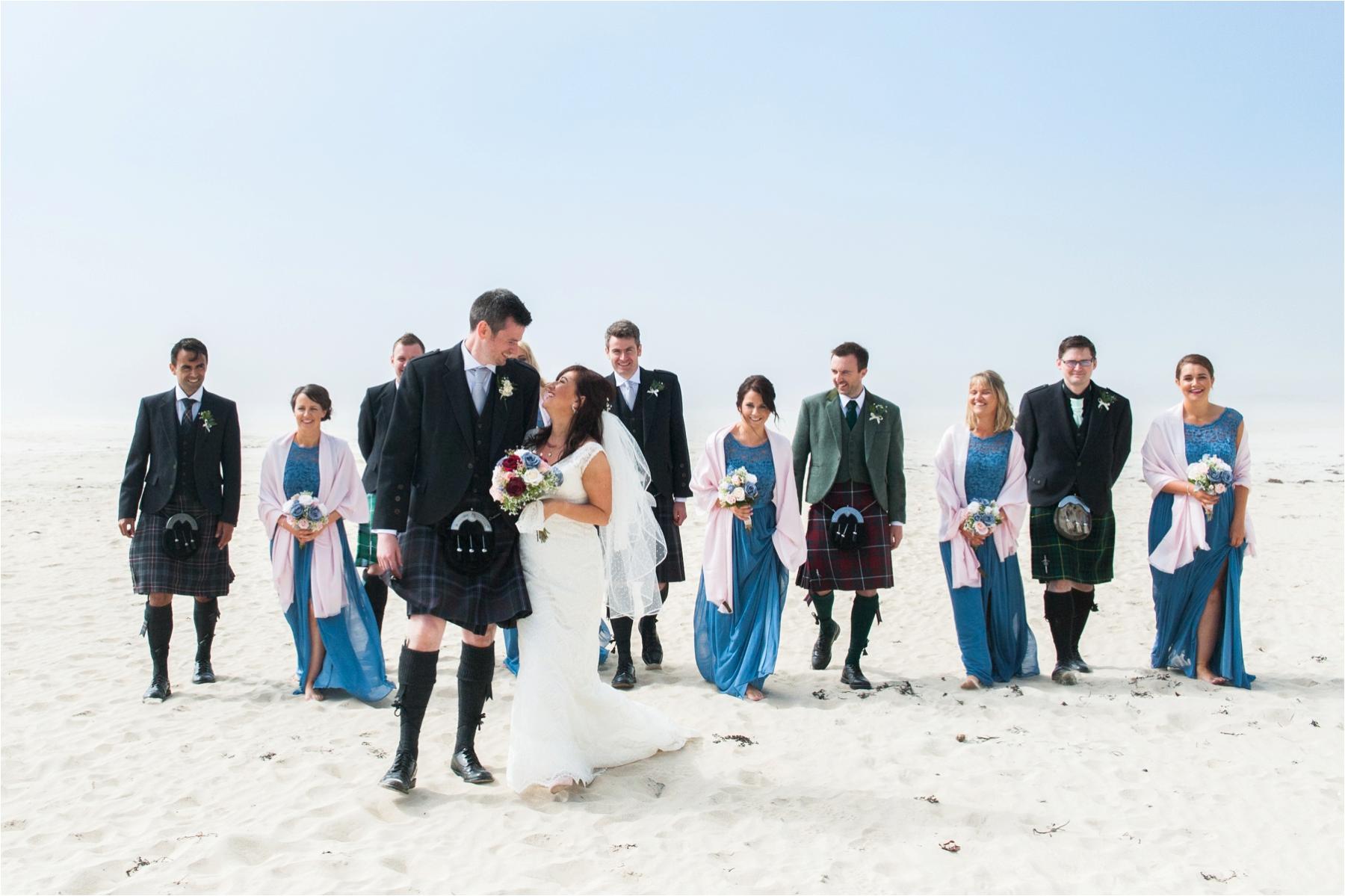 Bridal party celebrate at a beach wedding on the Isle of Harris. Photographer: Margaret Soraya