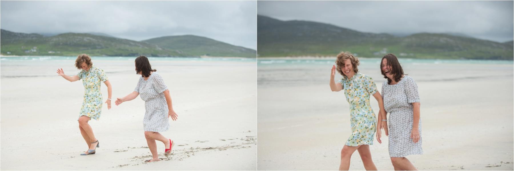 Luskentyre Beach wedding photography by photographer Margaret Soraya. Two brides hold hands on the deserted Outer Hebrides beach after their marriage. 