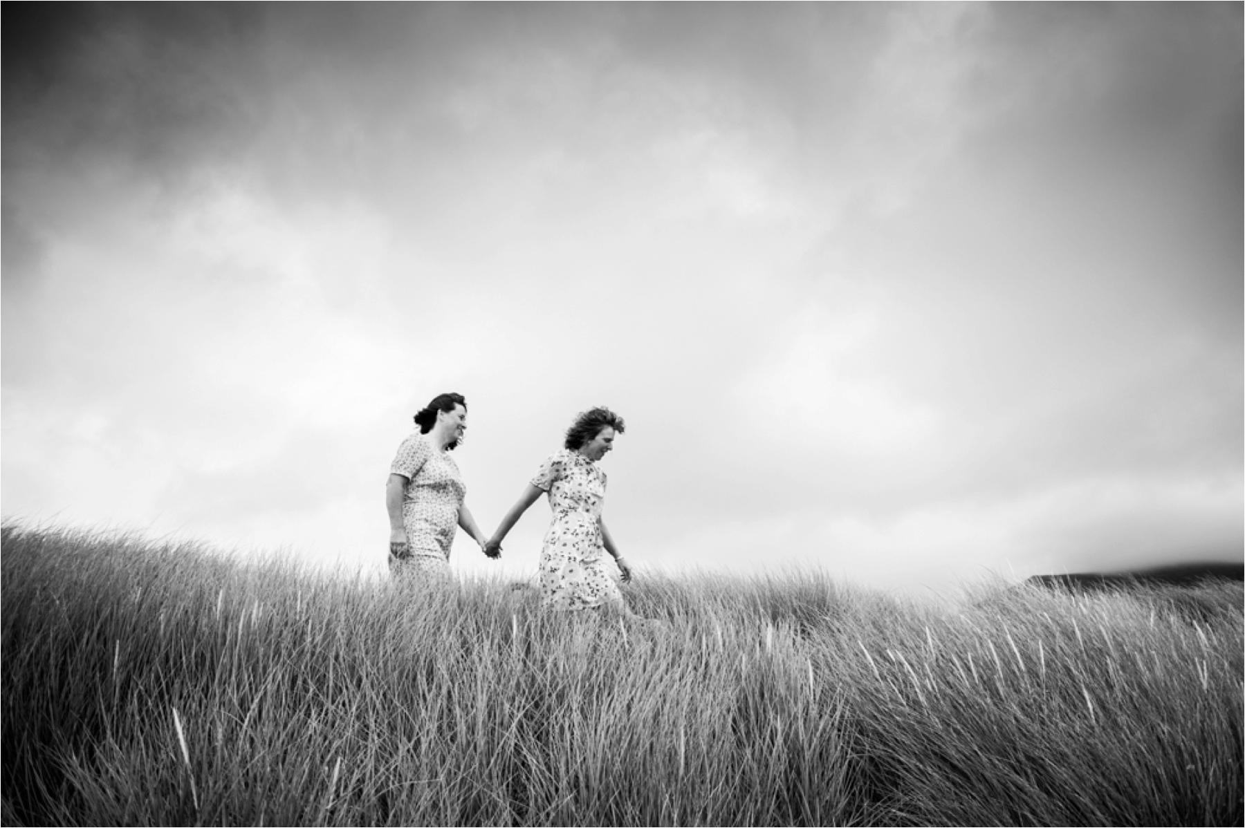 Black and white elopement photo of a couple in the sand dunes of Luskentyre Beach. 