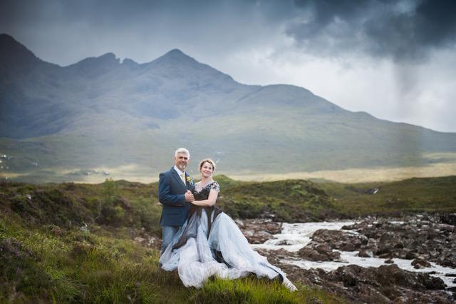 A Scottish island wedding with a bride and groom against stormy skies.
