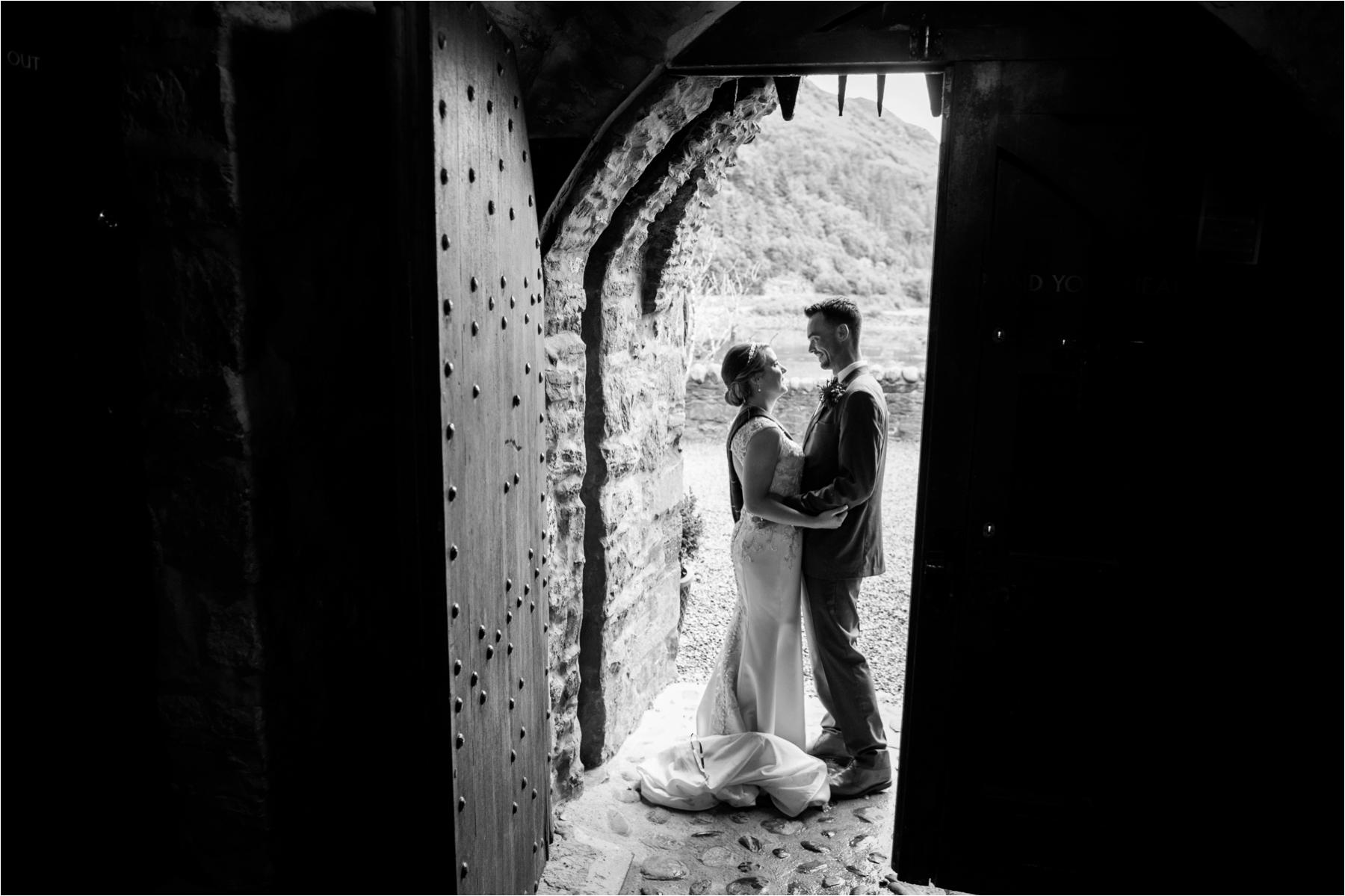 Wedding portrait doorway photo at romantic Eilean Donan Castle